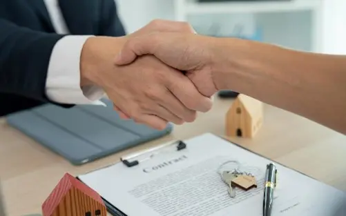 Business handshake over a contract.